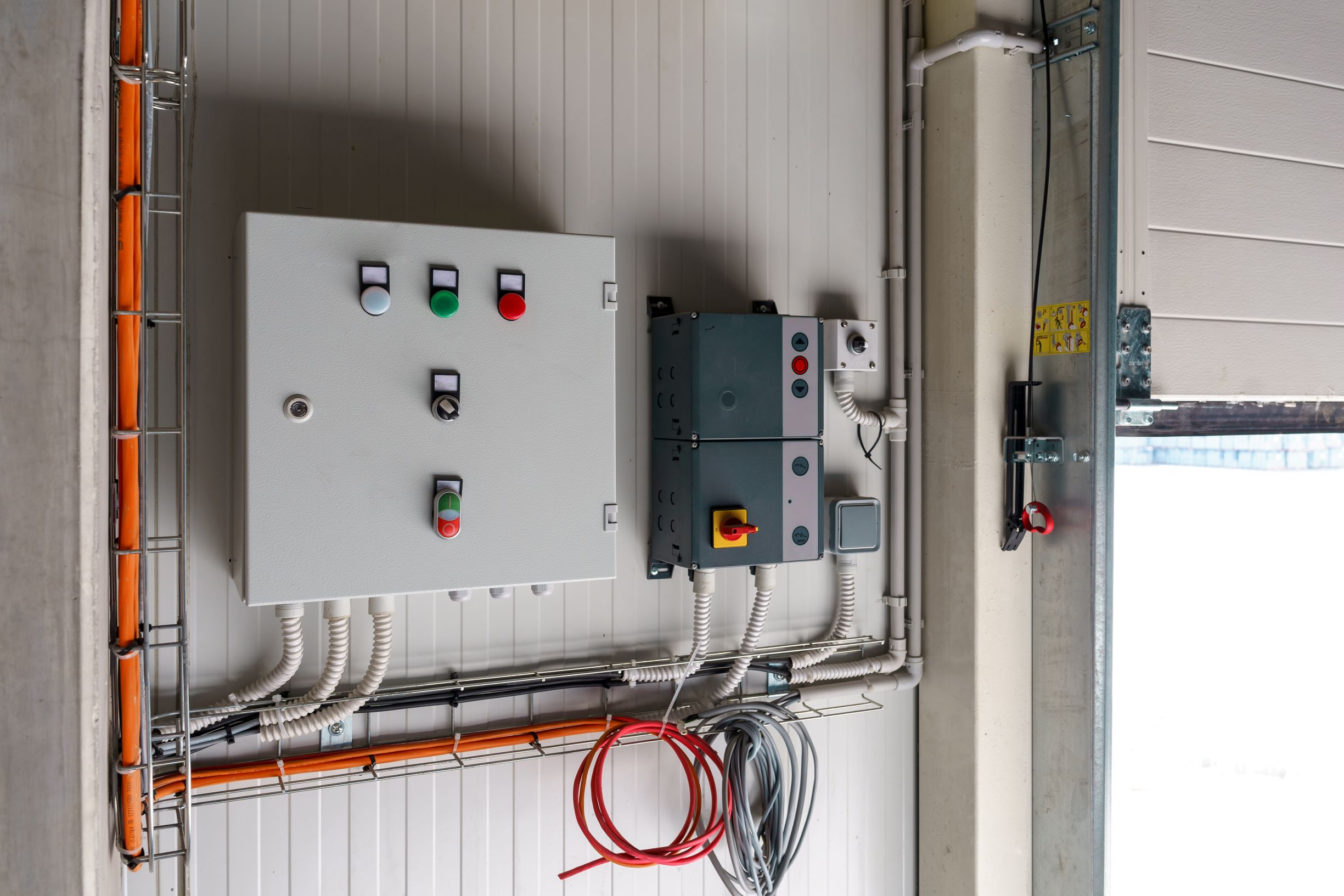 control panels and wiring on an industrial wall 2026 03 16 01 26 38 utc1 Overhead Door Opener Sterling Heights MI